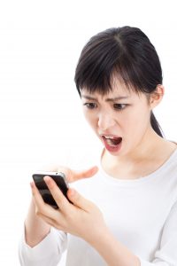 Woman angry at cell phone - Teen World Confidential