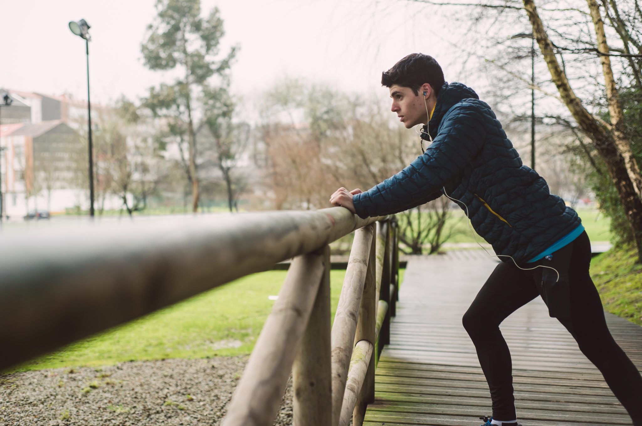 Runner man stretching in a park - Teen World Confidential