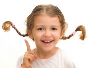 Positive thinking makes this cute little girl with pigtails smile. - Teen World Confidential