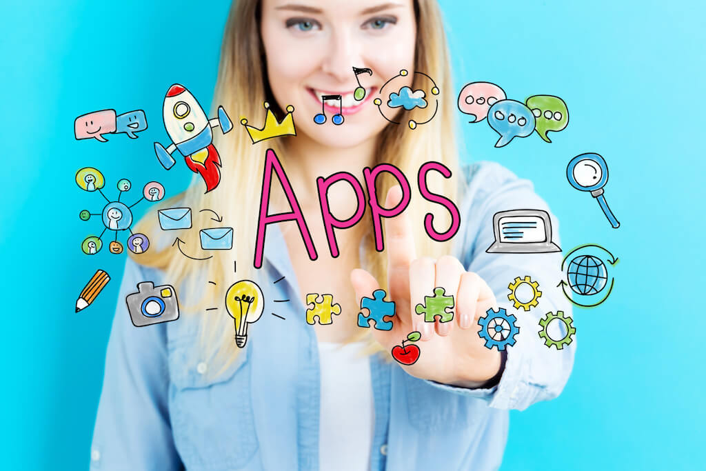 Young blond woman smiling with cartoon graphics and the word "apps" in front of her..
