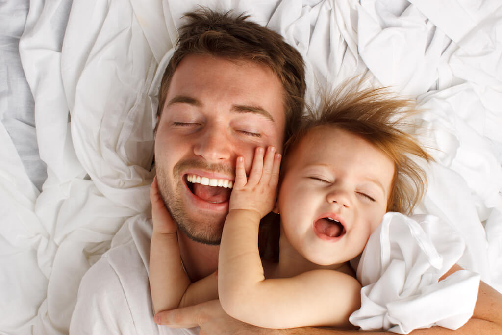 Dad and young daughter laughing and snuggling - Teen World Confidential