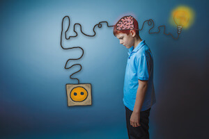 Boy with wire coming from brain into a plug