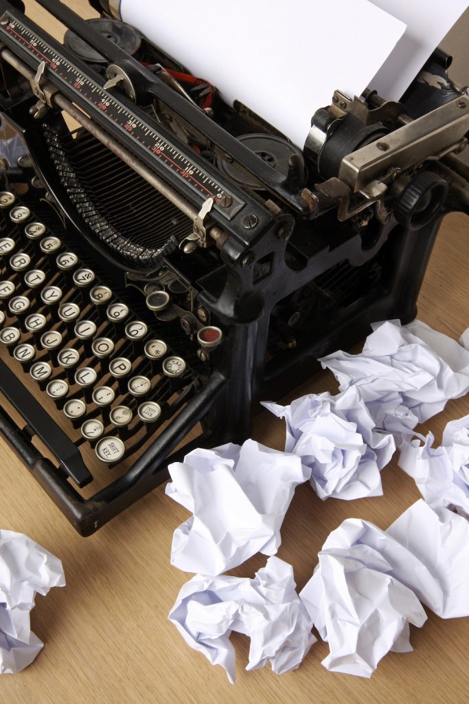 typewriter with crumpled paper