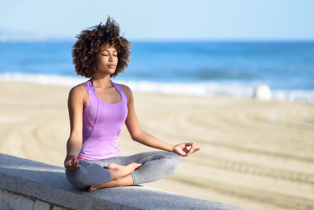 woman meditating on beach opt - Teen World Confidential