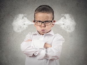 Little boy with glasses with smoke of anger blowing out of his ears